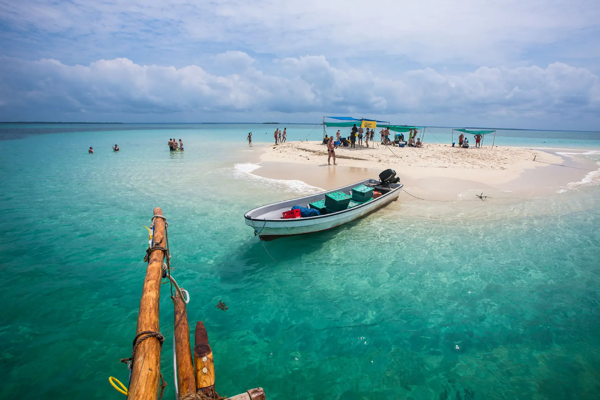Boat anchored by a sandbank in shallow turquoise water