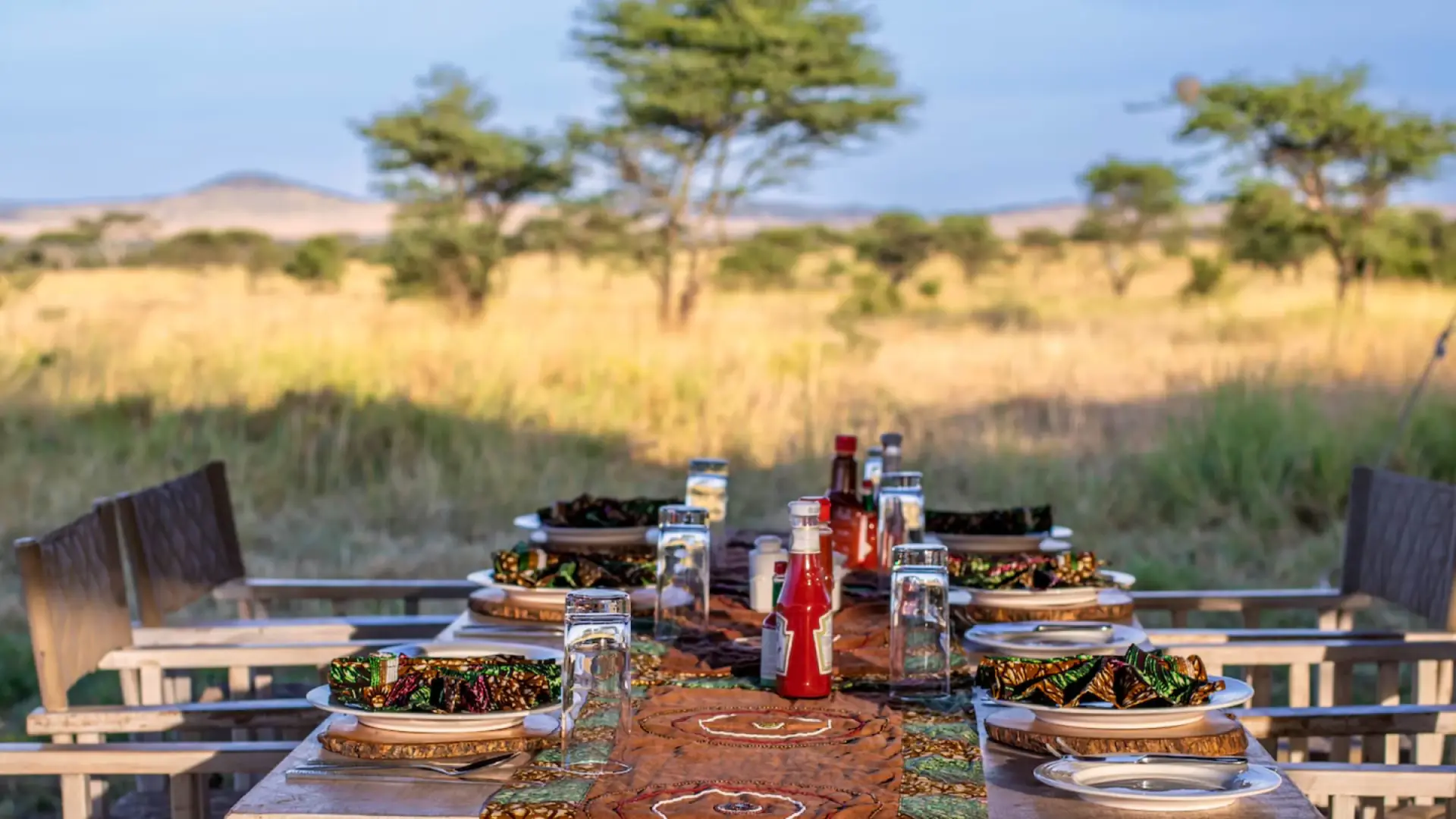 Dinner table set for guests on the open savanna