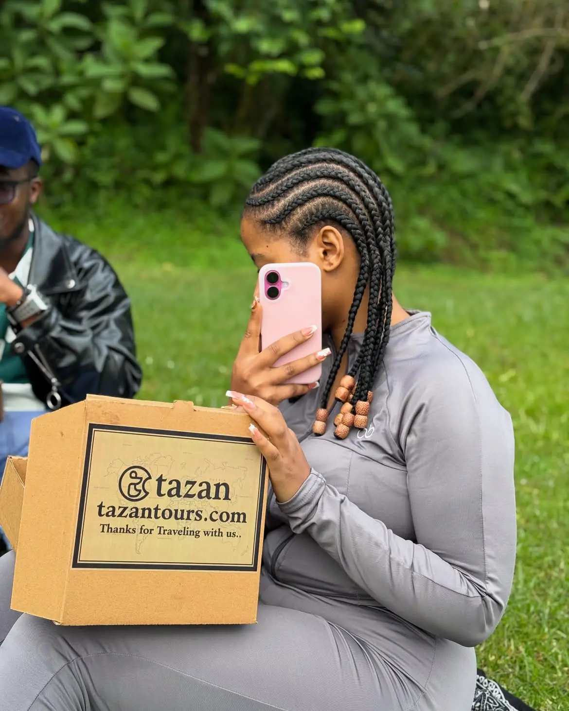 A guest holding a Tazan Tours thank-you package at the end of their trip