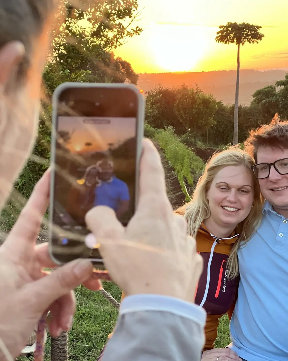 A guest couple with their guide at golden hour