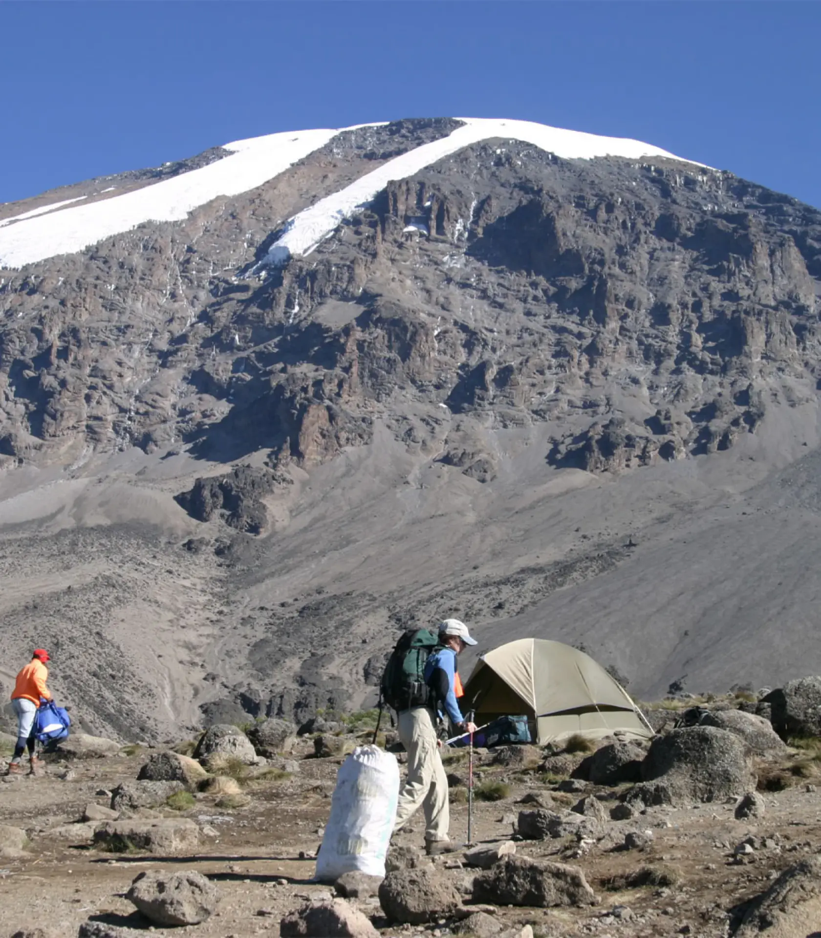 Trekker below the rocky slopes near Lava Tower
