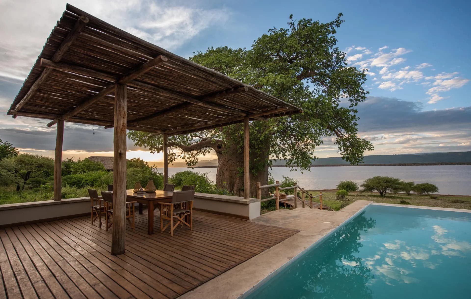 Shaded dining terrace and pool beside a baobab tree, overlooking Lake Manyara at Manyara's Secret