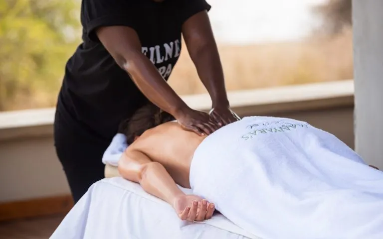 Guest receiving a massage on an open-air terrace at Manyara's Secret
