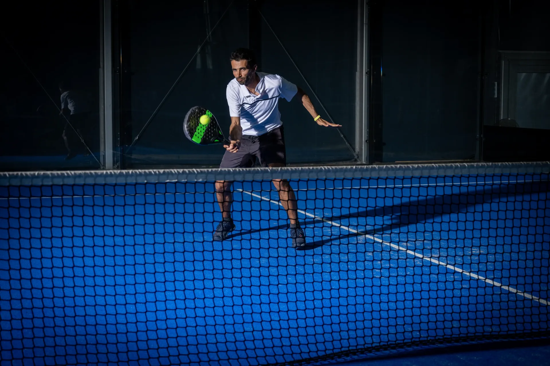 Guest playing padel on a blue court at Z Hotel