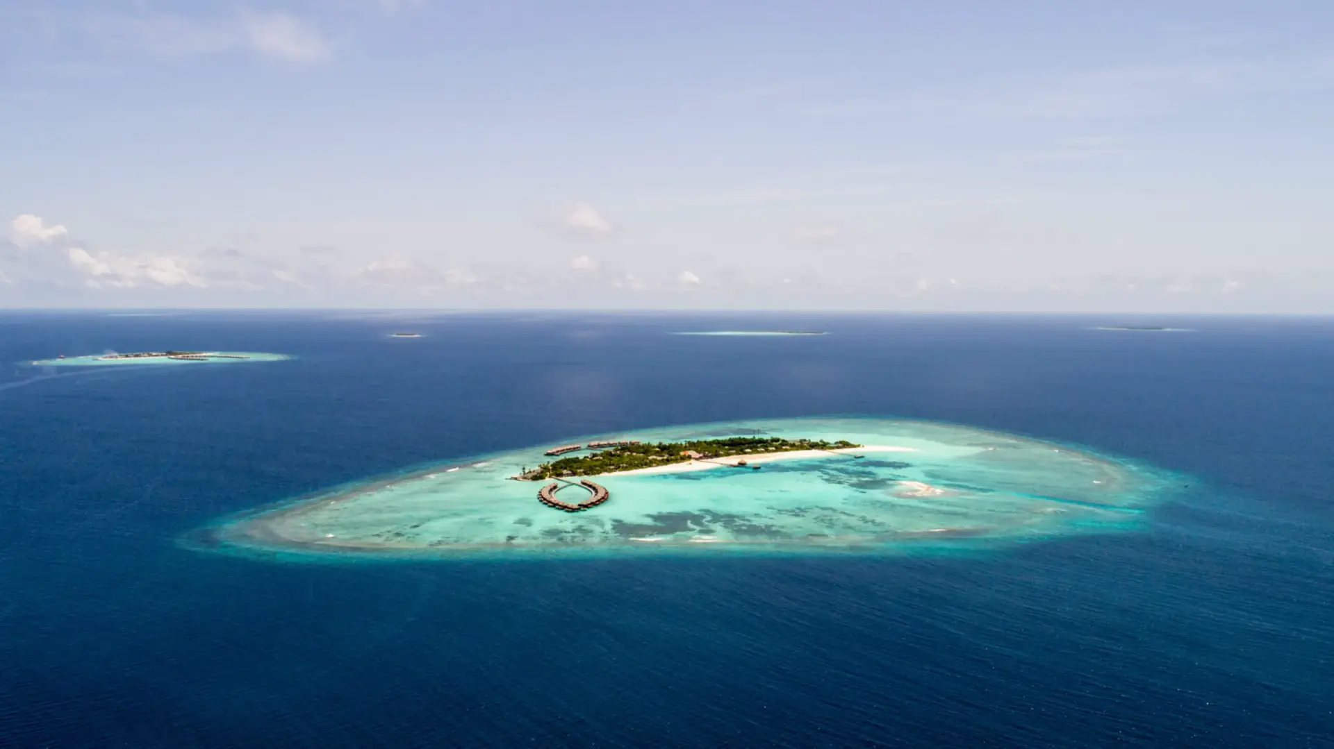 Aerial view of a small island ringed by turquoise reef off Mafia Island