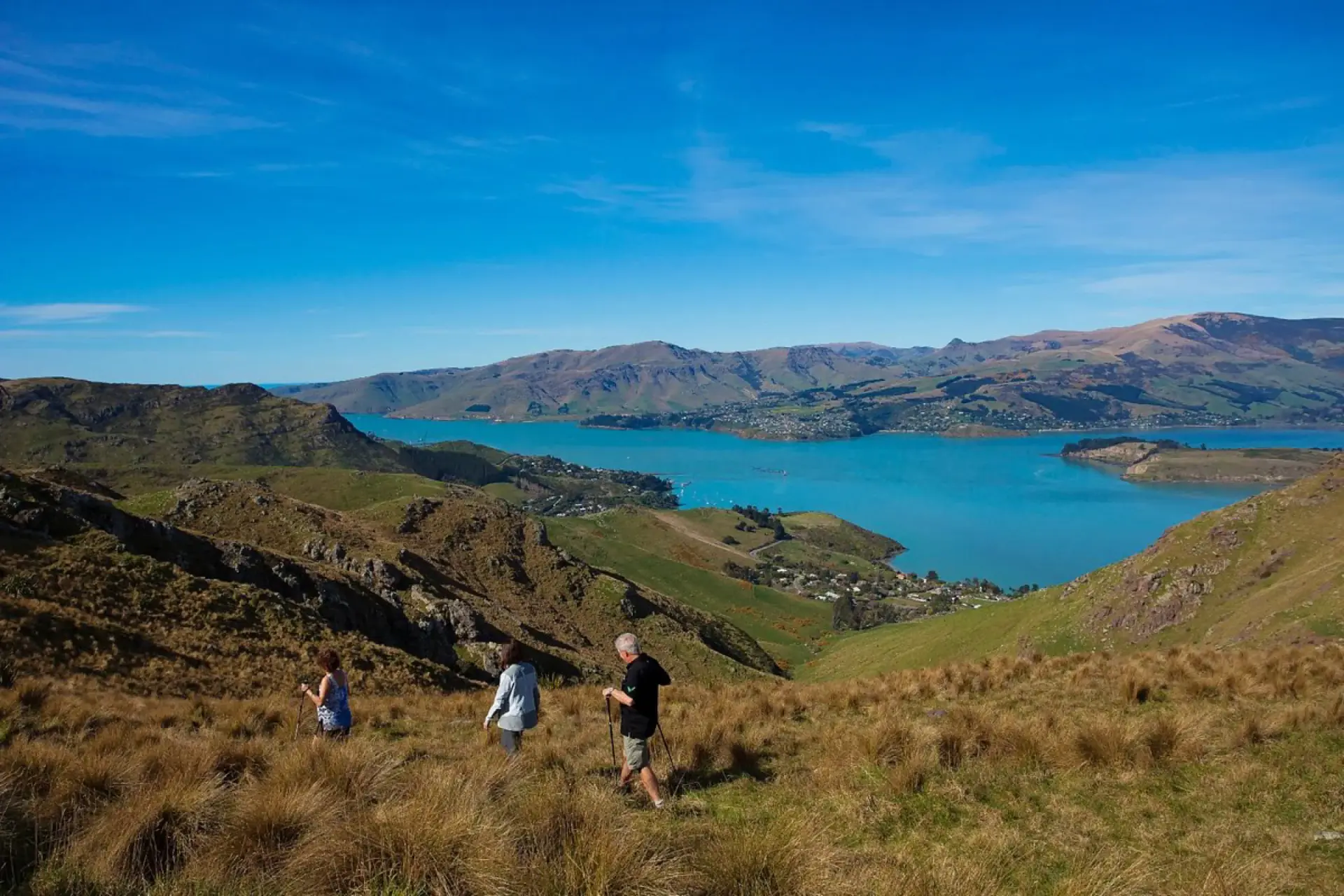 Hikers on the grassy slopes above the Empakaai Crater lake