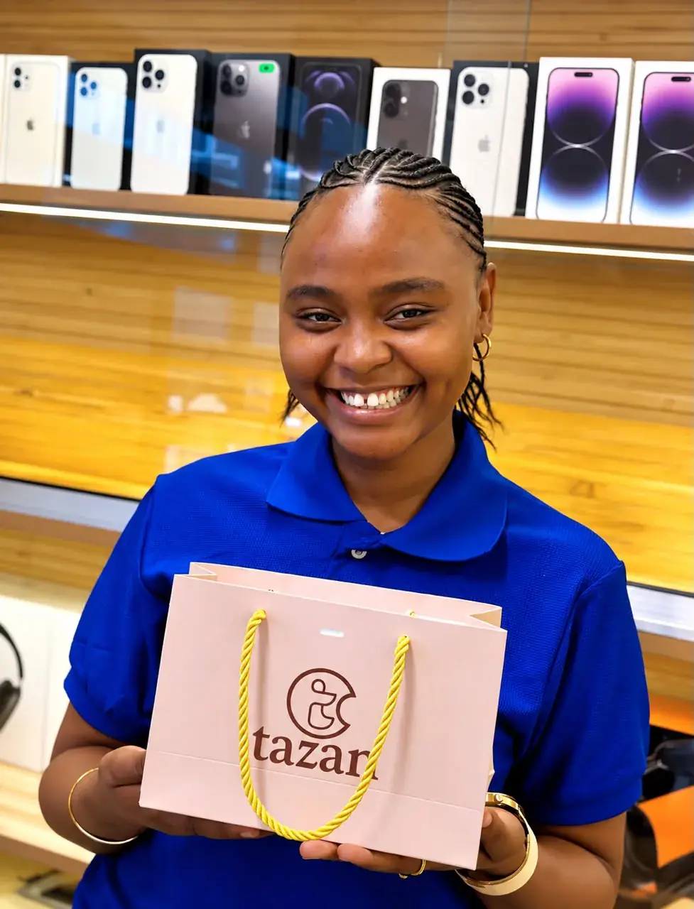 Smiling client holding a gift bag at Tazan Stores