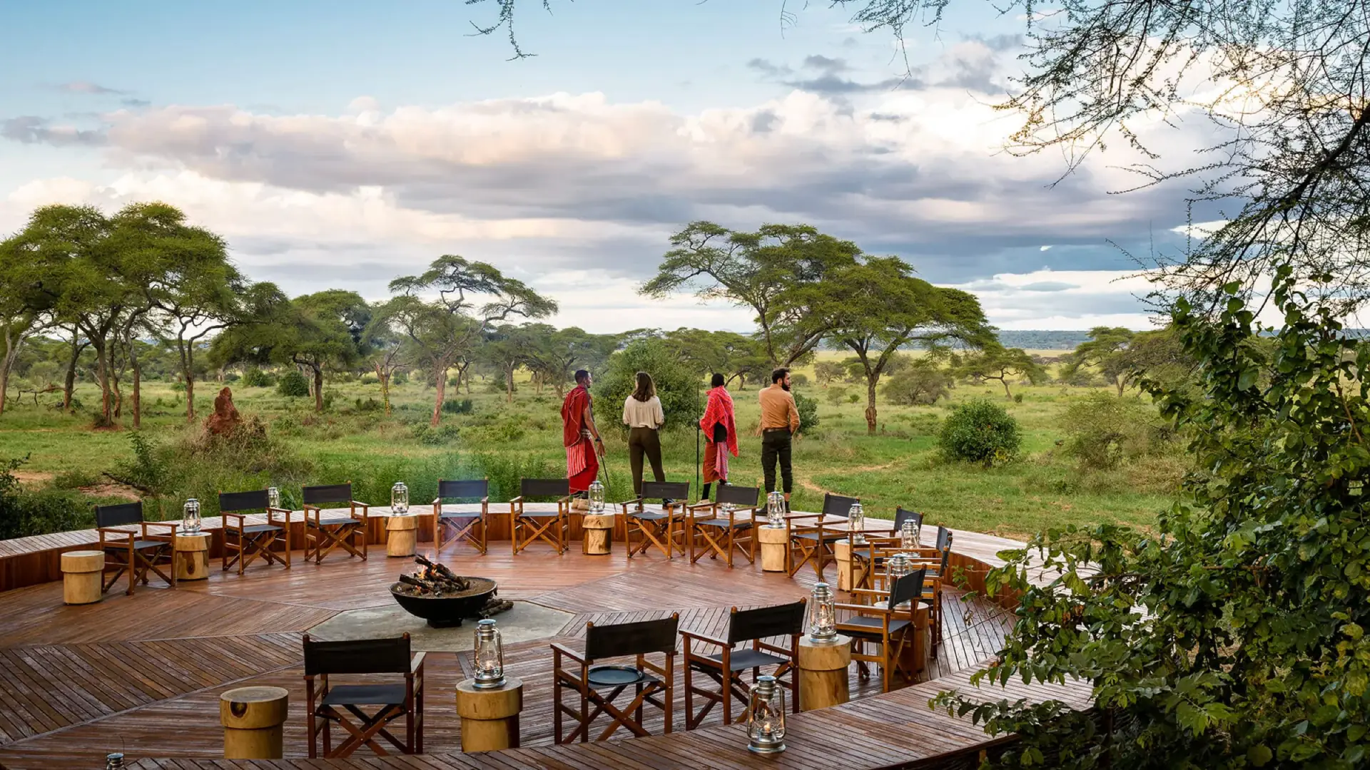 Safari camp deck with a fire pit and Maasai hosts