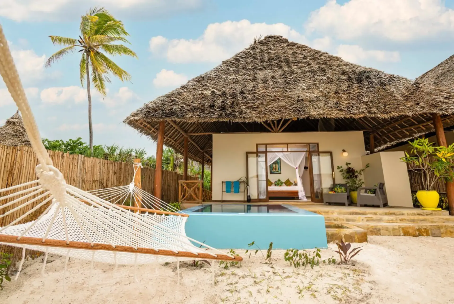 Thatched beach villa with a private pool and hammock in Zanzibar
