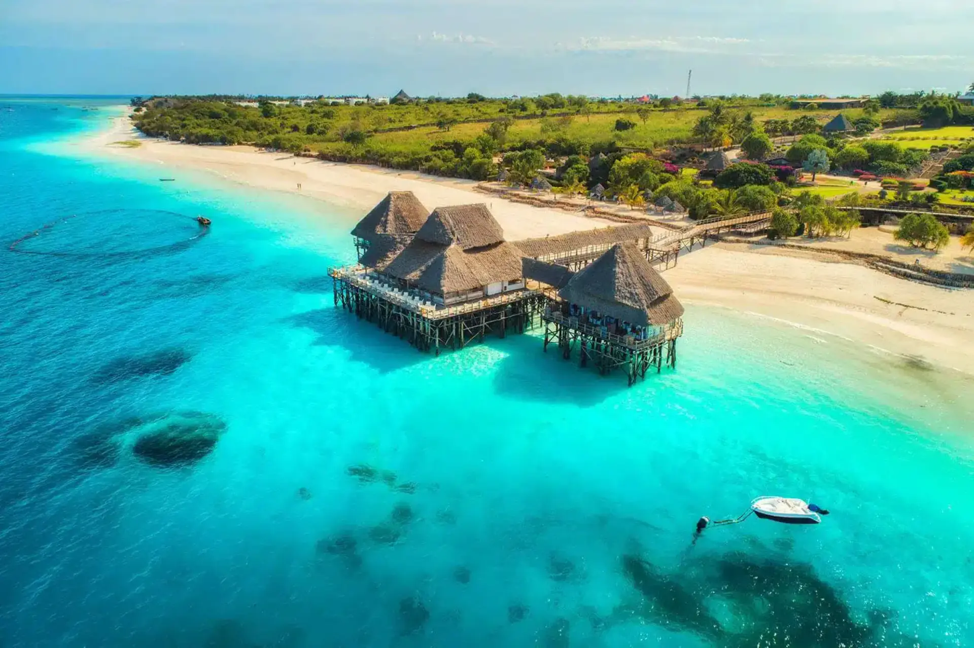 Aerial view of overwater bungalows on a Zanzibar beach