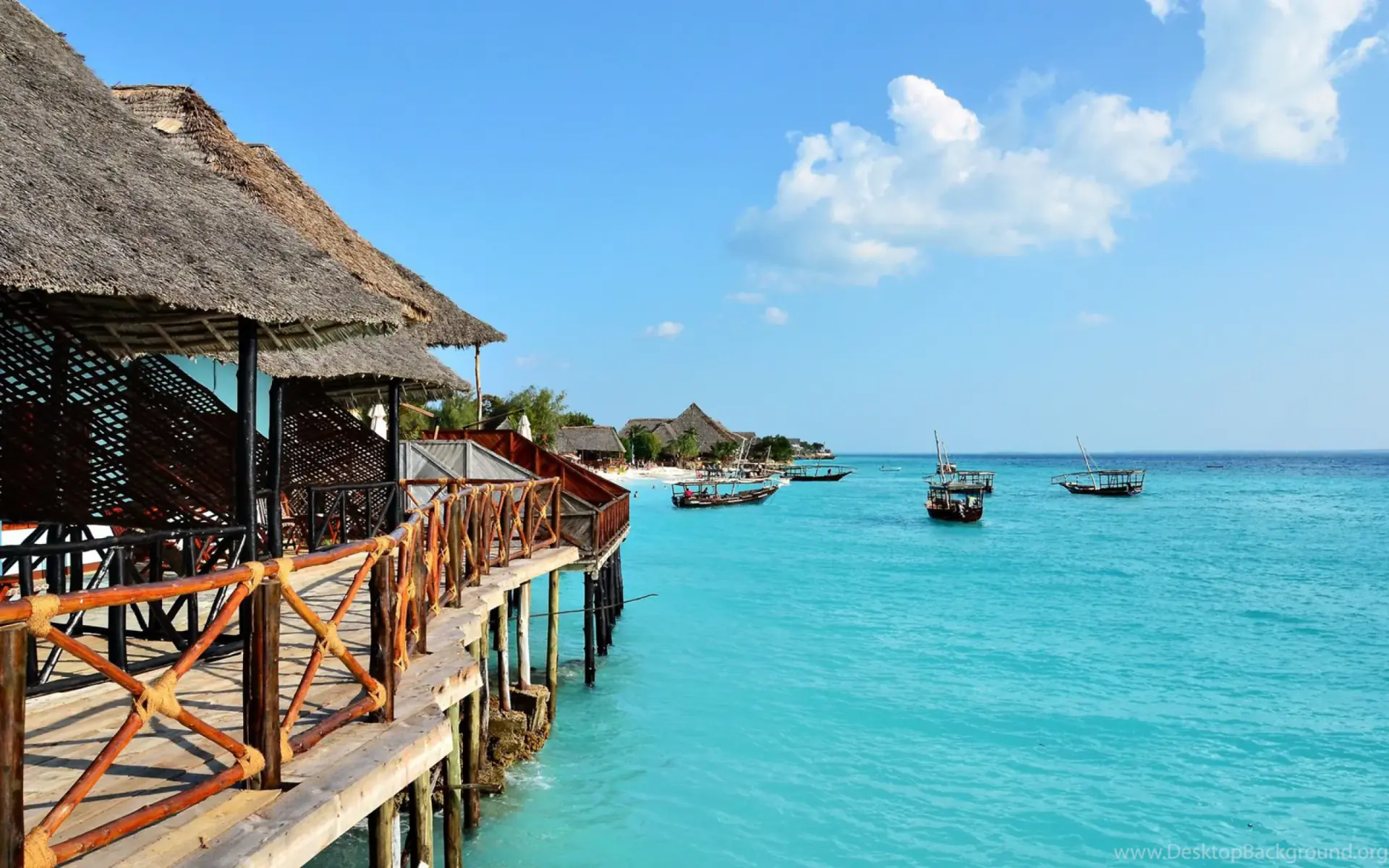 Overwater restaurant deck with boats on the turquoise sea